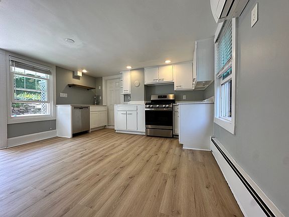 Kitchen with updated flooring, ample cabinetry, and individually controlled mini-split heating and cooling