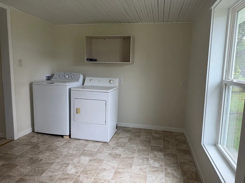 Large entry/mud room with full size washer and dryer.