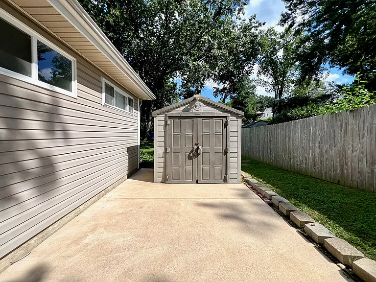 Backyard patio with storage shed.