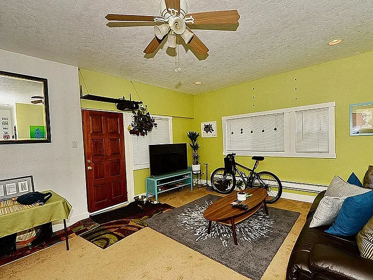 Main living room with high ceilings gives a large and roomy feel for this cozy 1 bedroom home.