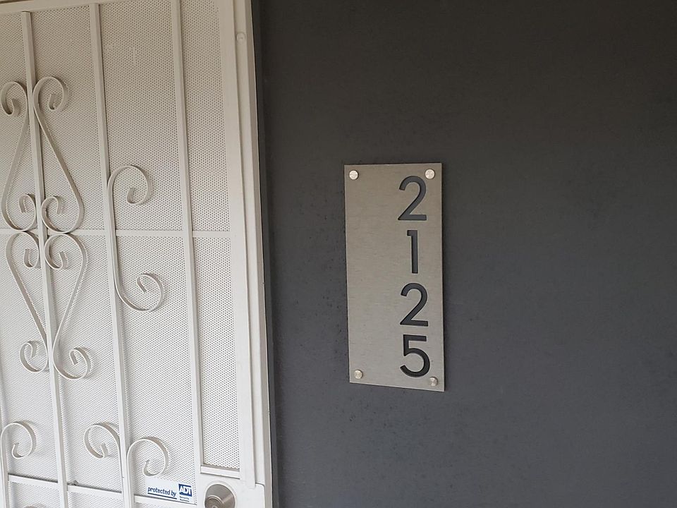 Metal screen door with deadbolt. New exterior lights by the door and by the garage.