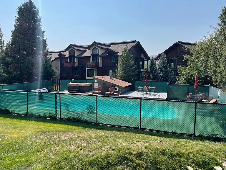 Shared pool and hot tub area right across walkway from condo