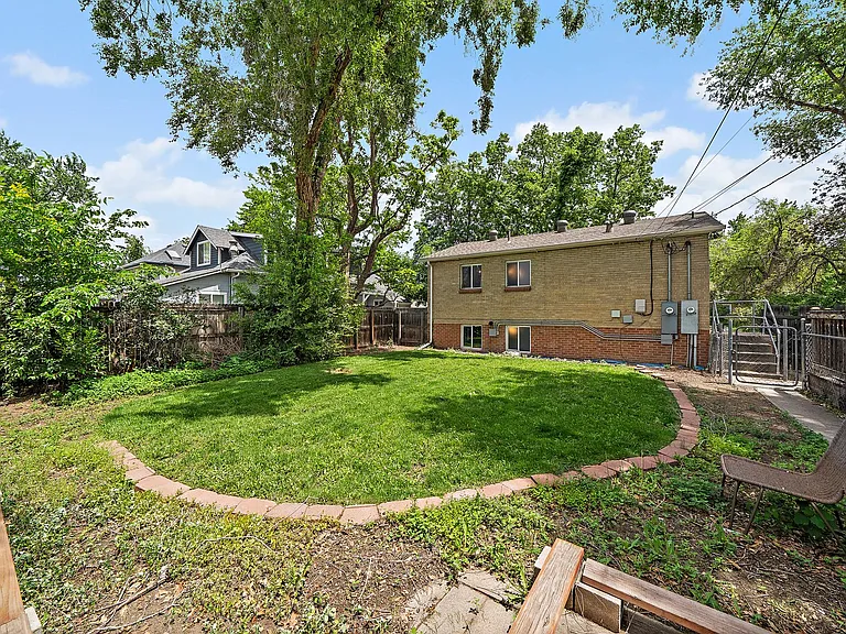 Backyard from Southwestern perspective at garage access entry door.
