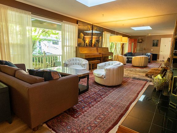 Front living room with wood burning fireplace and piano
