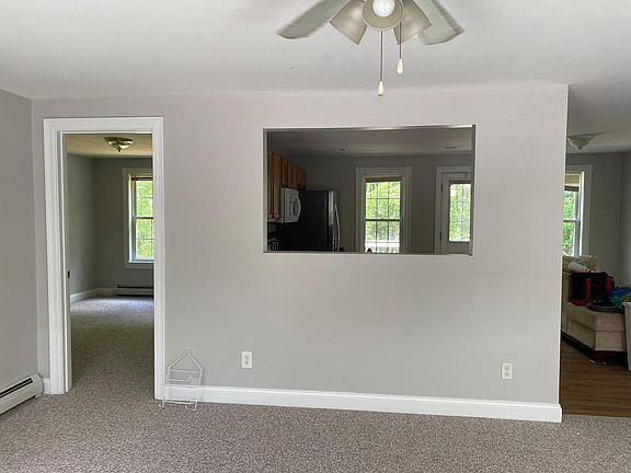 Living room looking through to kitchen with first floor bedroom on the left and bathroom