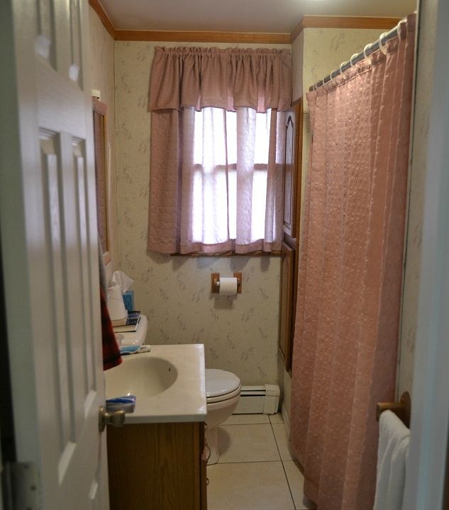 The home has 2 full baths.  Easy access from the main floor to this bathroom just inside the back entrance.  It features a tub/shower combo, ceramic flooring and a good sized vanity.  