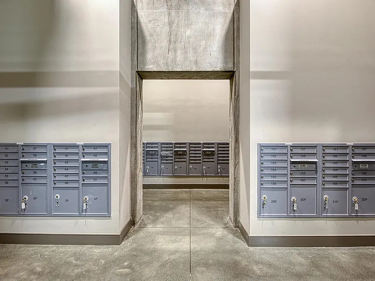 Mailroom hallway with organized mailboxes and clean, streamlined walls for easy mail access.