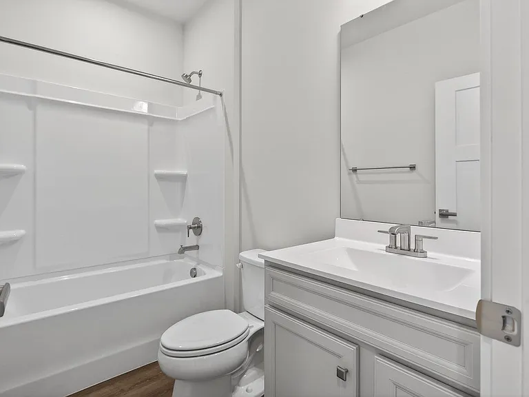 3rd floor hall bathroom with culture marble countertops and tub/shower