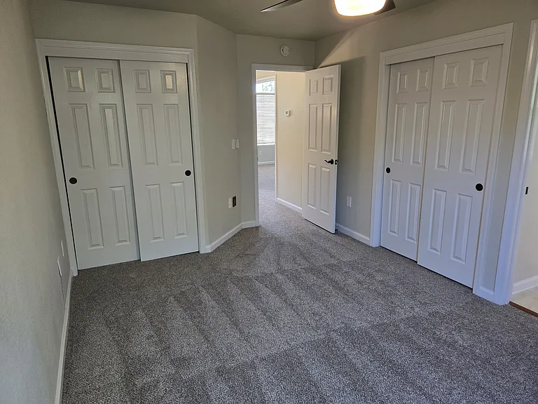 Second private primary suite features plush new carpeting, two spacious closets, ceiling fan, and its own private en-suite bathroom.