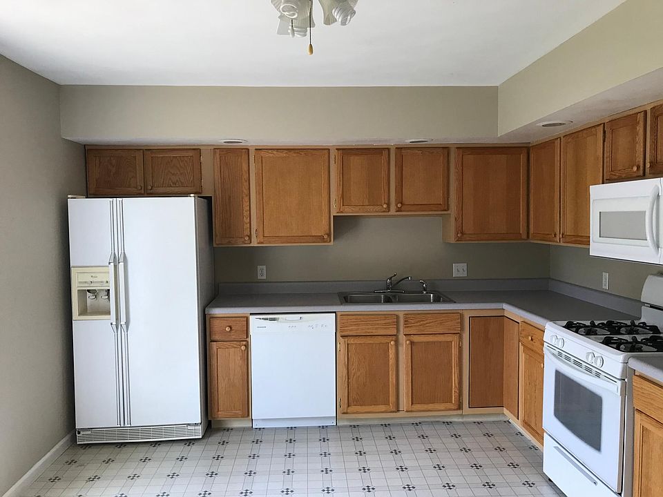 Kitchen view from dining area. Sliding glass door to the deck is located on wall to left of refridgerator.