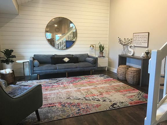 Living room with vaulted ceilings, shiplap and newer laminate flooring.