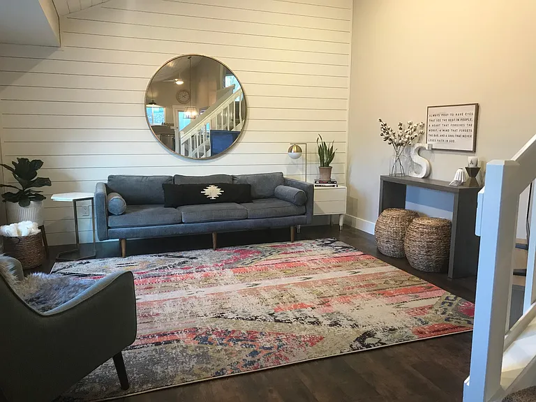 Living room with vaulted ceilings, shiplap and newer laminate flooring.