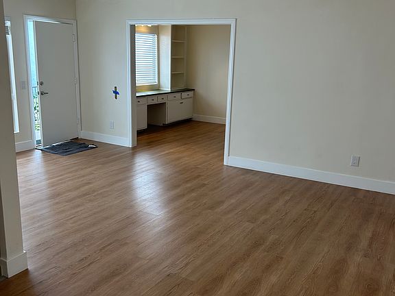 View from living room looking toward entrance and den