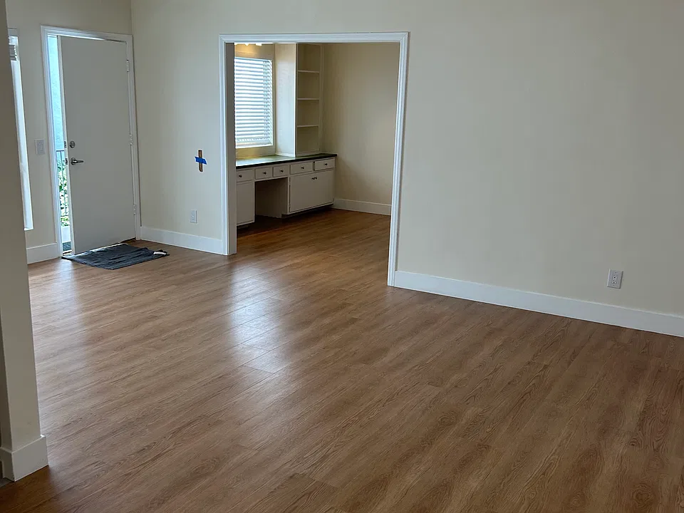 View from living room looking toward entrance and den