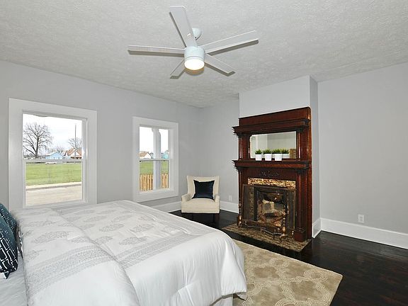Master bedroom with decorative fireplace