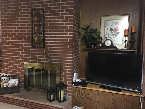 Living room with wood burning fireplace.
