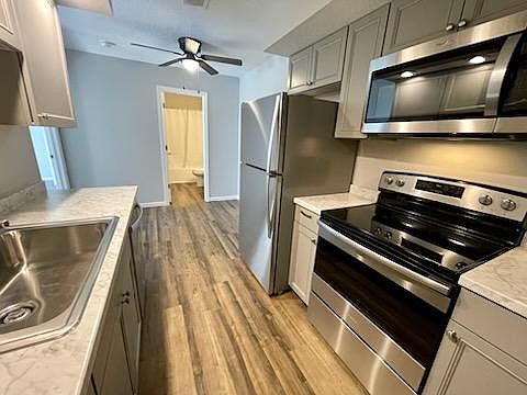 Enter the unit into your new kitchen. Includes new cabinets, new counter tops, new sink, faucet & disposal, new floor, & new appliances.