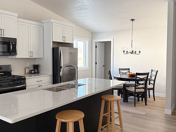 door down the stairs goes to the garage, door by the kitchen table goes upstairs to the bonus room