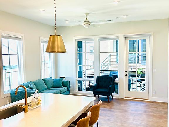 Stylish living room with sofa, barstools, television