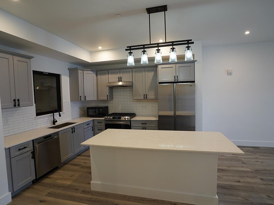 Kitchen includes microwave, fridge/freezer, dishwasher, gas stove, and garbage disposal.