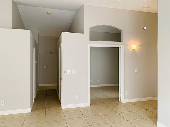 View of secondary bedroom and hallway from dining room