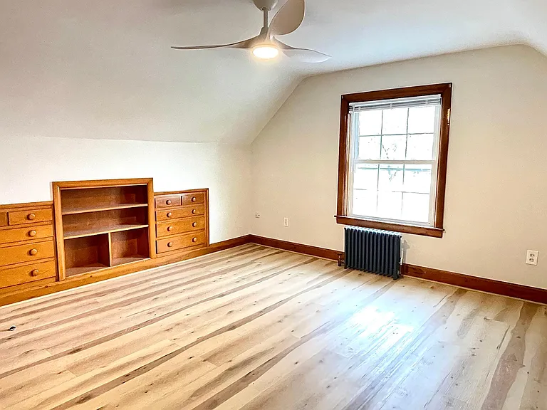 2nd-floor bedroom with built-in dressers and bookcase, new ceiling fan with remote, and brand new flooring