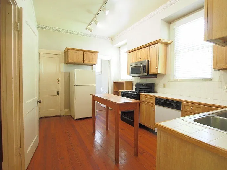 Huge Kitchen - Hardwood floors, tiled Countertops, built in microwave, extreme storage, Walk In Pantry, track lighting, easy access to basement, next to breakfast room, wood blinds