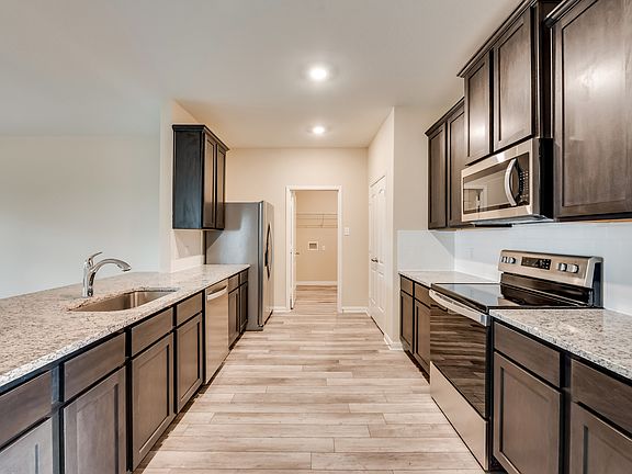 The kitchen comes with a full suite of stainless steel appliances