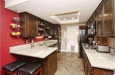 Kitchen with Stainless Steel appliances. Granite counters and ti
