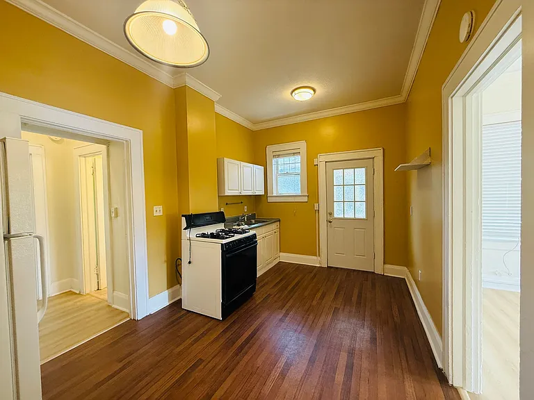 another view of eat in kitchen with door leading to covered back porch