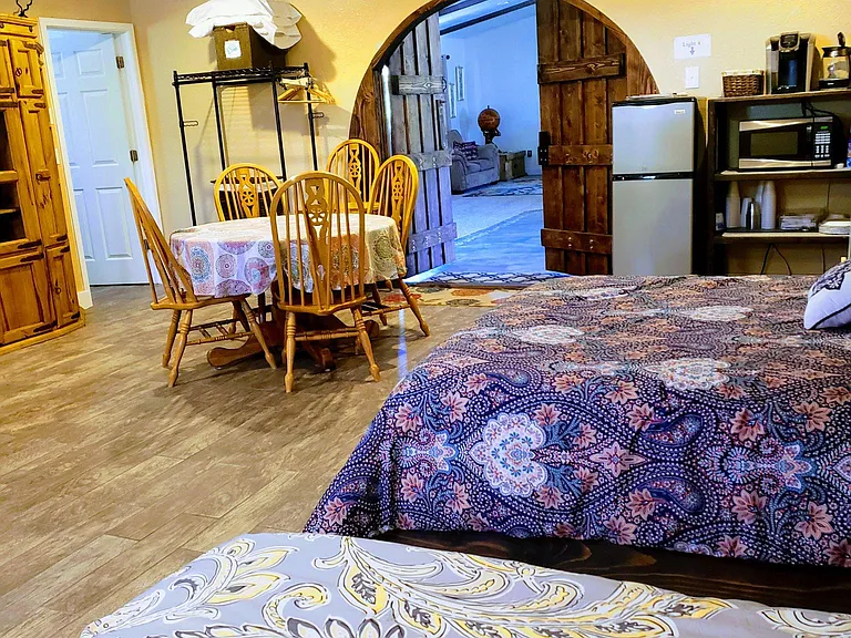 Bedroom 1: Mother-in-law Suite 
This is a huge room with two beds, a private entry, a private bathroom, a private patio, a mini kitchenette area, a tv, and a fireplace. We use this room as a guest room, and it's basically a tiny house.