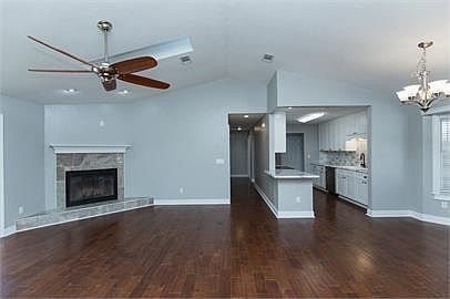 Great room with view of kitchen and hallway to second and third bedrooms