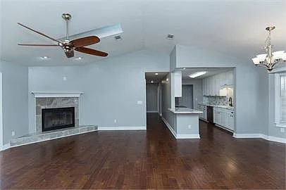 Great room with view of kitchen and hallway to second and third bedrooms