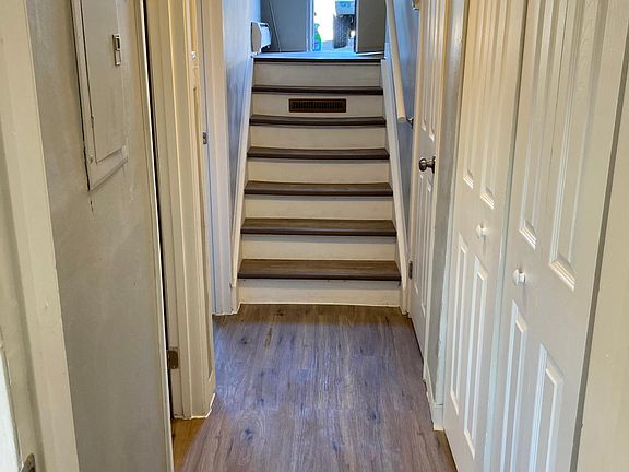 Downstairs hallway with storage closet and laundry closet with washer drier hookups