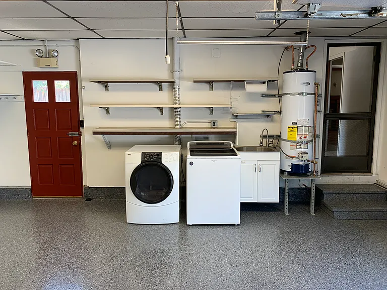 Attached garage with durable finished flooring and abundant storage