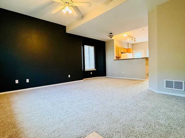 Main-level living area with open view toward kitchen, actual photo