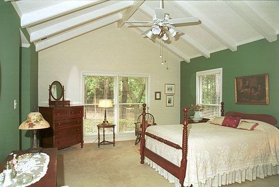 Large Master Bedroom with vaulted ceiling, beamed ceiling, crown moulding.