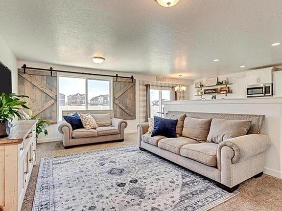 What you see when you open the front door. Similar but not exact decor (couch, loveseat, rug) provided by landlord. TV can be added by any tenant as circumstances permit.