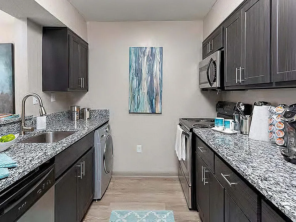 Explore this sleek kitchen designed with modern amenities and stylish finishes.