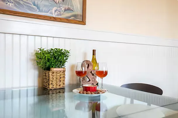 Cozy designer table and leather stools for a glass of wine and a meal.
