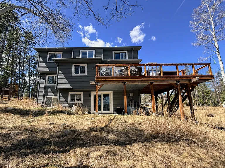 Back view of home, 3 level home with walkout patio doors. Home also has a doggie door built into home