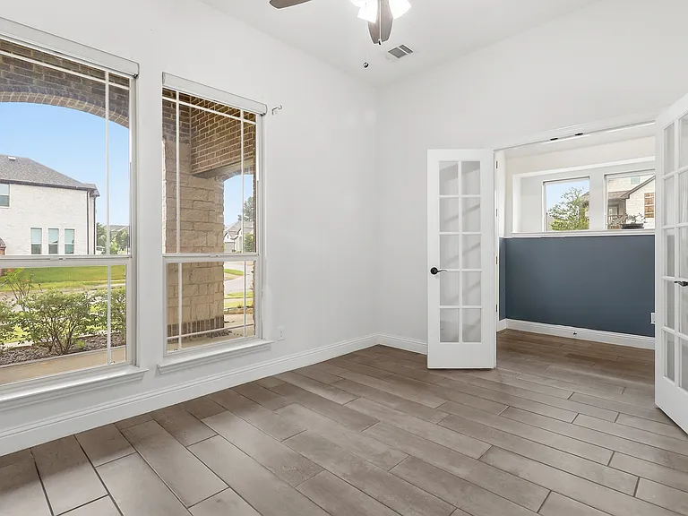 Office Room/Library featuring wood-finish with French Doors flooring, white walls, and a ceiling fan