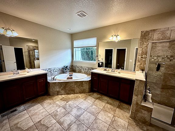 Master ensuite bathroom with two walk in closets