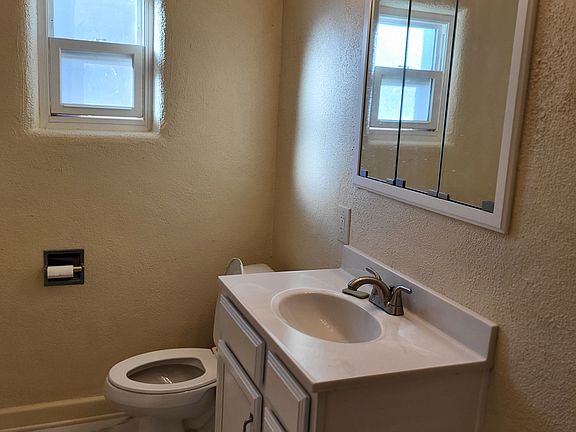 Bathroom 2 of 2: new vanity, mirror, and toilet. Includes 3-function ceiling heat fan, exhaust fan, and light.