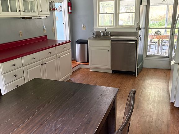 Kitchen with a high top table, dishwasher, microwave, and stove.