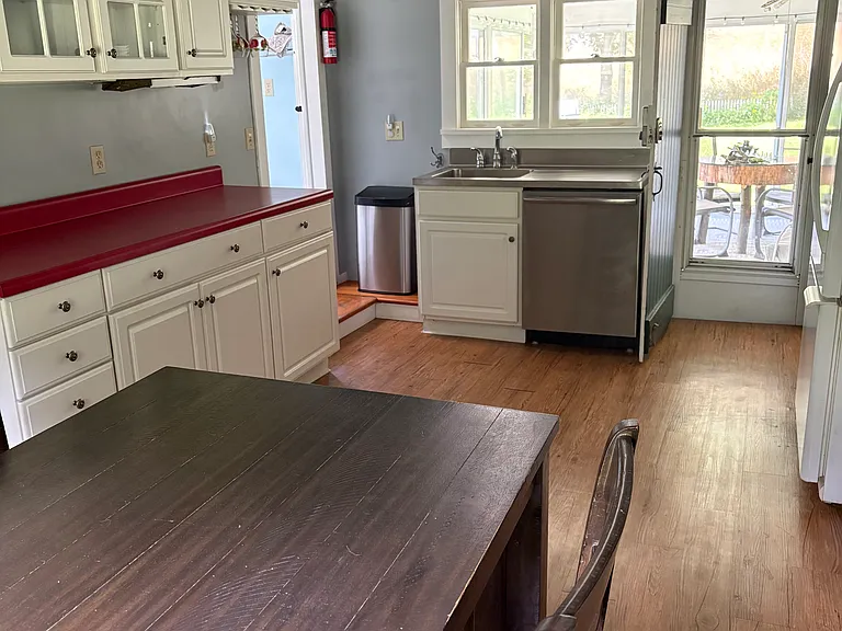 Kitchen with a high top table, dishwasher, microwave, and stove.
