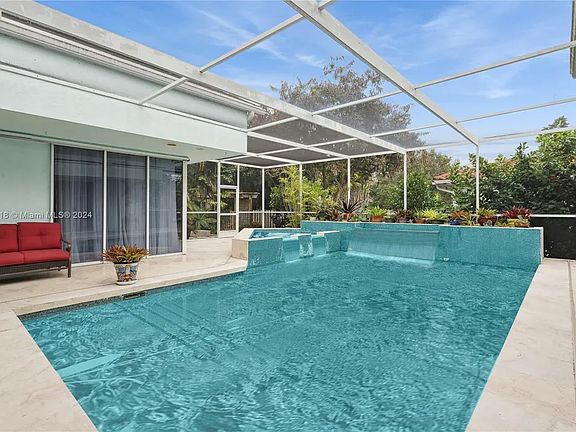 Screened pool and spa surrounded by the home
