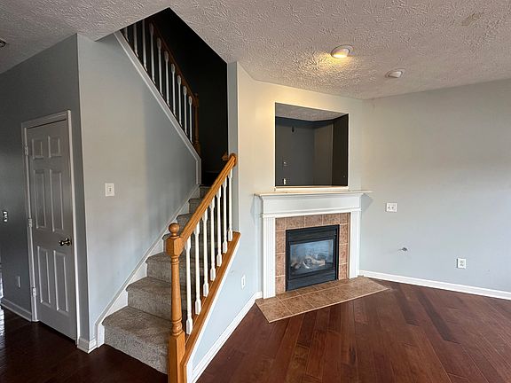 Gas fireplace opposite of the kitchen.