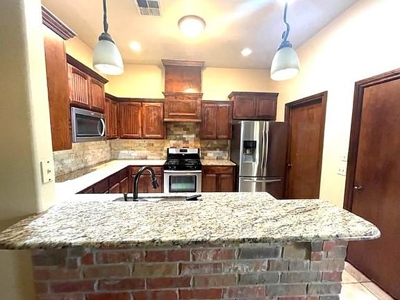 Kitchen with Stainless Steel refrigerator.