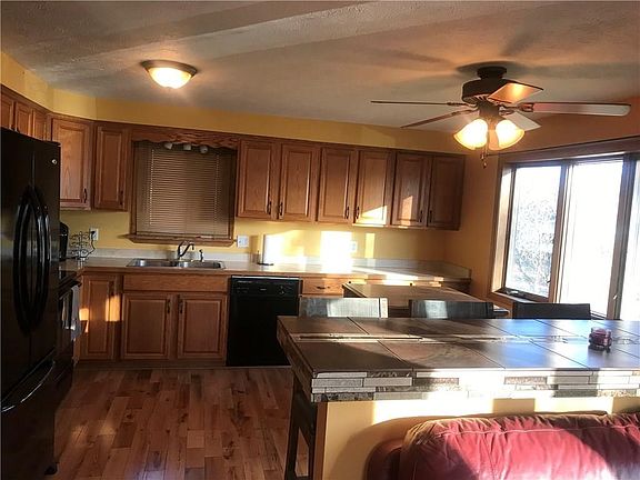 KITCHEN WITH BOW WINDOW, ISLAND AND HARDWOOD FLOORS. APPLIANCES INCLUDED